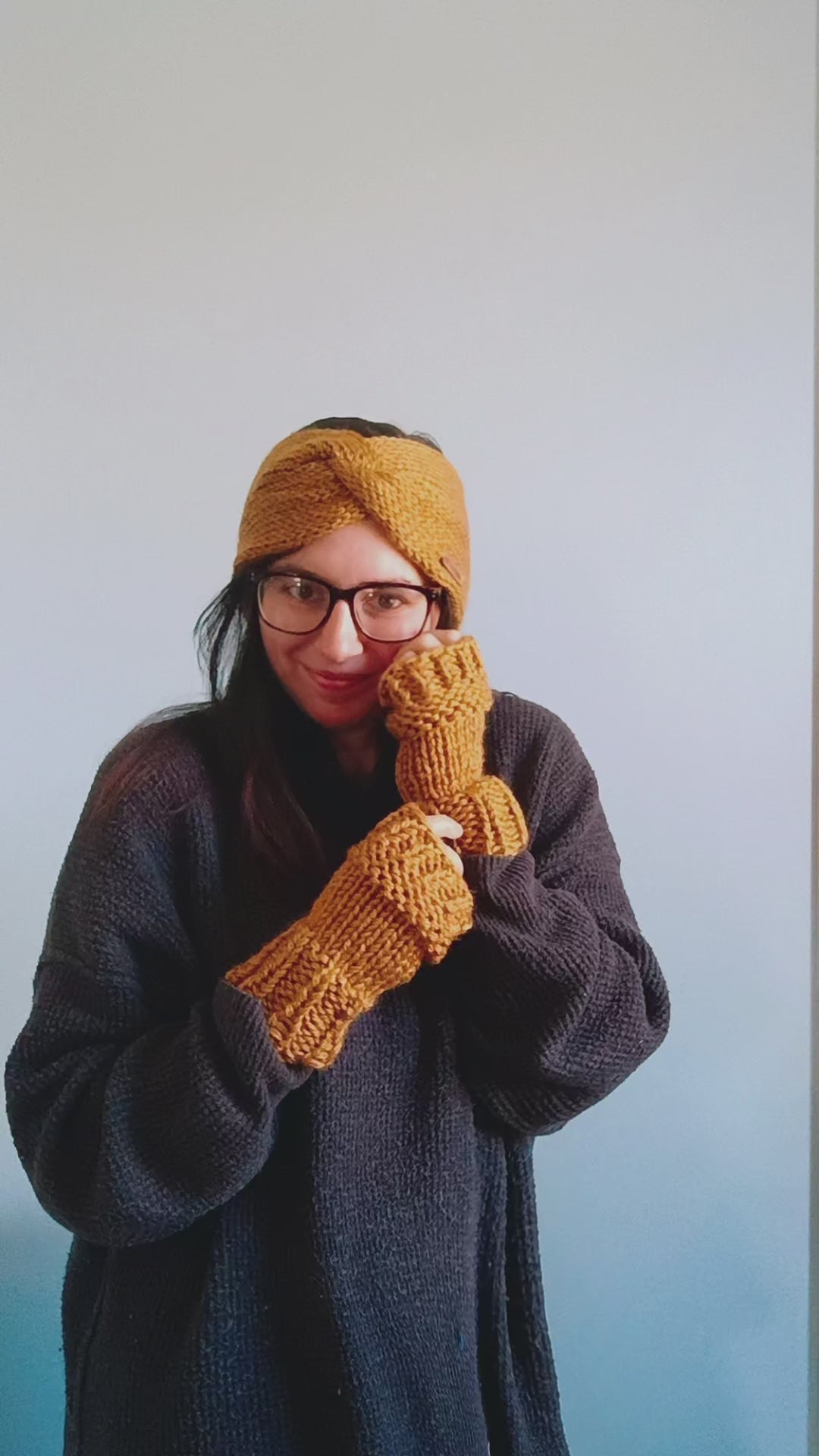 Slide video of a women posing differently with her matching gold ear warmer and fingerless gloves on