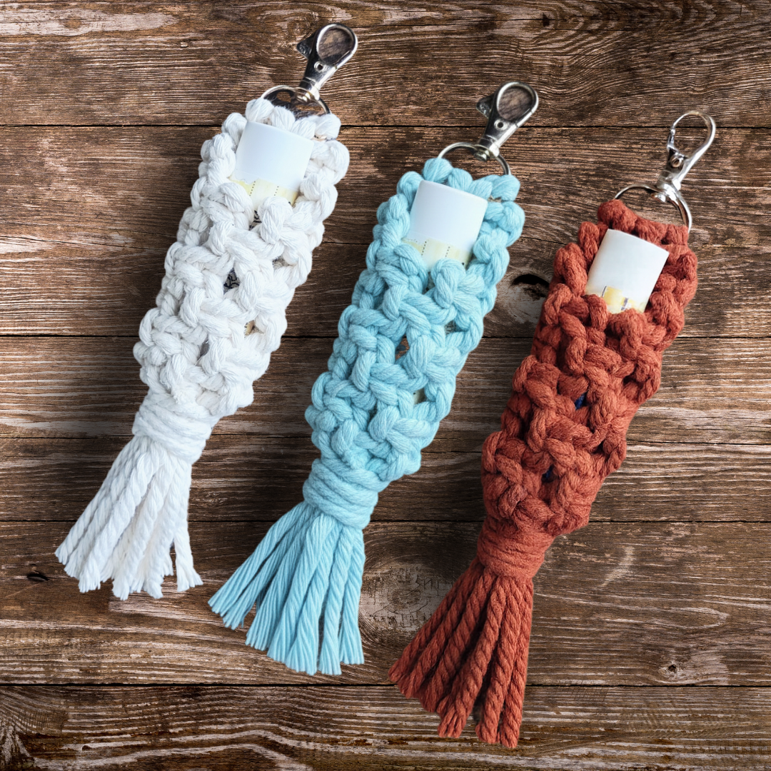 three Macrame chap stick holders one in beige, light blue and rusty red