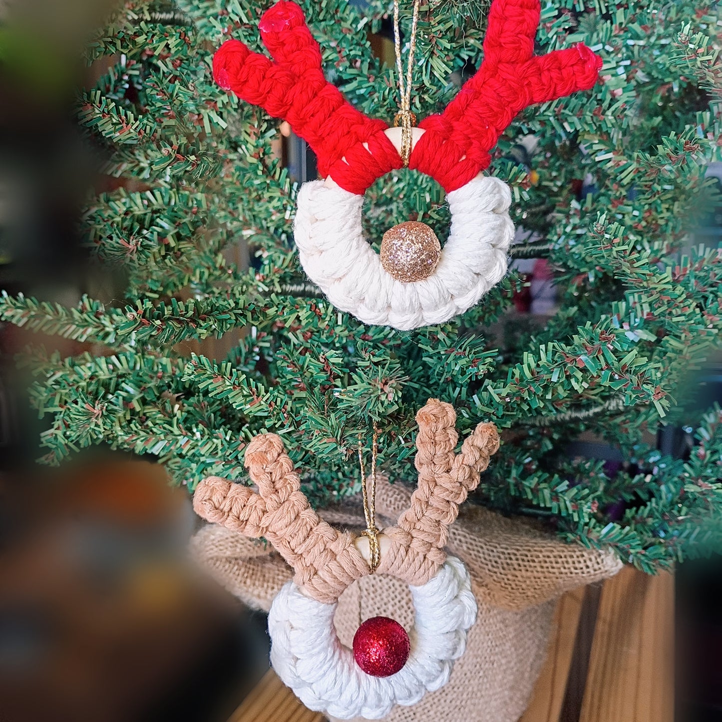macrame reindeer ornament with sparkle red or gold ball as the nose, one red antlers, one with tan antlers 
