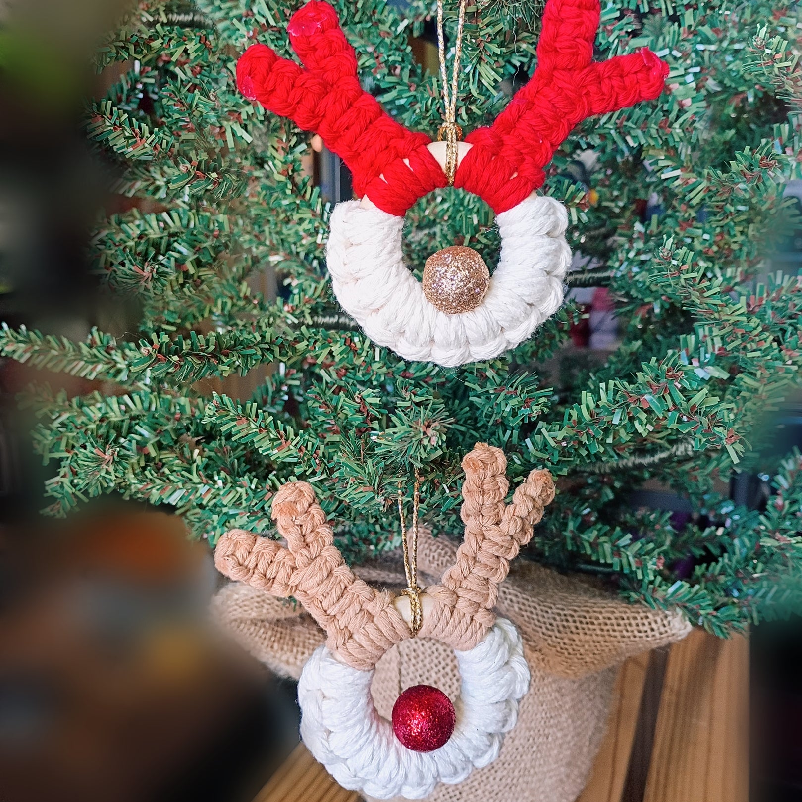macrame reindeer ornament with sparkle red or gold ball as the nose, one red antlers, one with tan antlers 
